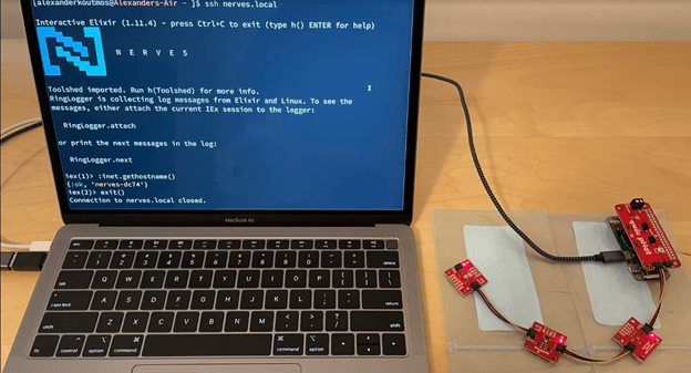 A picture of laptop running Nerves IoT framework connected with IoT sensors.